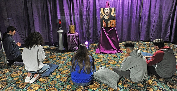 Students from St. Joseph University School pray in the make-shift chapel during 